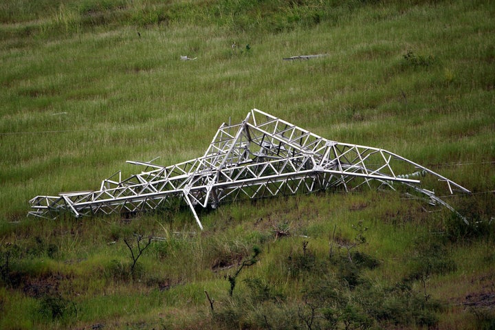 A twisted power distribution line tower is crumpled on the ground on Oct. 28, 2017, after the passing of Hurricane Maria in Guayama.