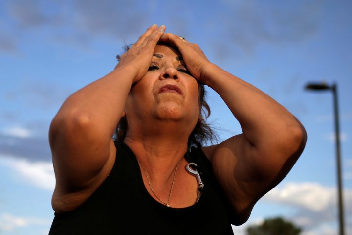 A woman reacts after the mass shooting in El Paso.