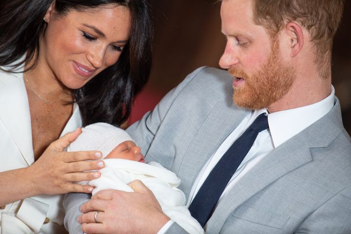 Meghan and Harry cradle little Archie at his first official photo call in May.