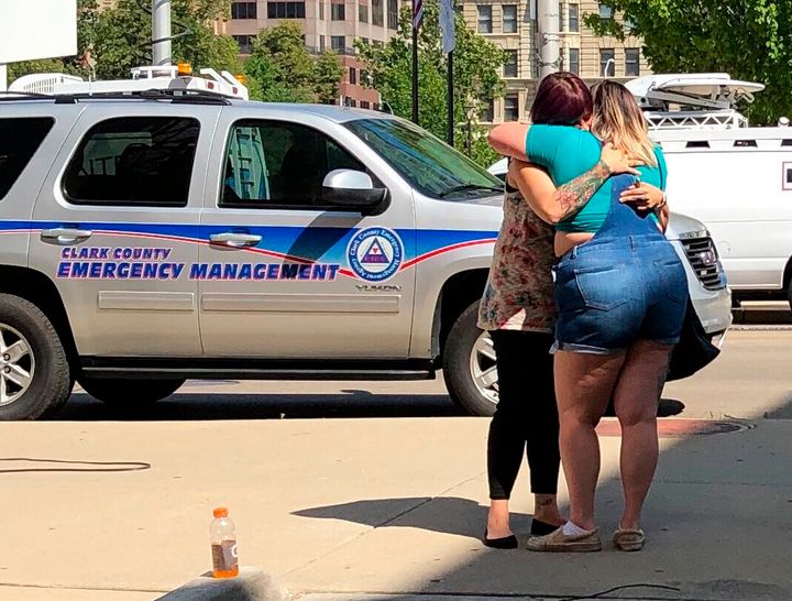 Residents comfort each other as they await word on whether they know any of the victims of a mass shooting on Sunday, Aug. 4, 2019, in Dayton, Ohio.