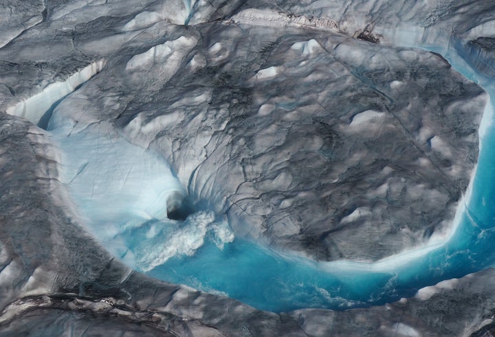 In this image on Aug.1, 2019, large rivers of melting water form on an ice sheet in Greenland and drain through holes into the ocean. The heatwave that smashed high-temperature records in five European countries accelerated the melting of Greenland's ice sheet and caused massive ice loss in the Arctic.