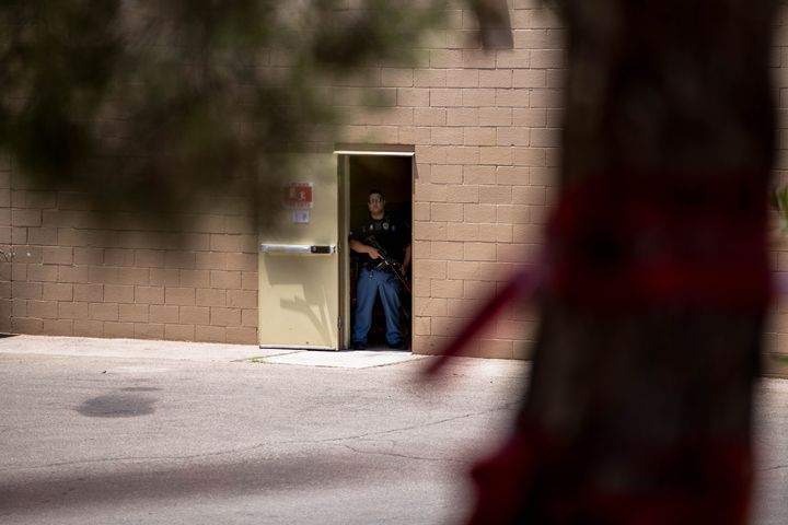 A law enforcement officer covers an exit of the Walmart where a gunman opened fire in El Paso, Texas on Aug. 3, 2019.