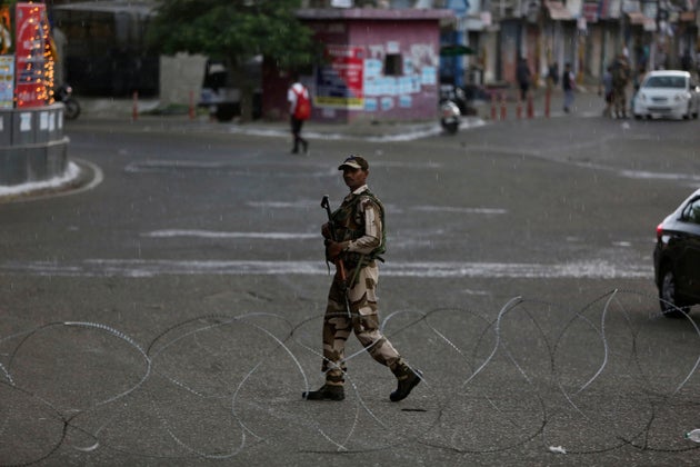 An paramilitary soldier guards during security lockdown in Jammu, Aug. 5,