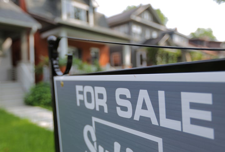 A sign advertises a house for sale in midtown Toronto, July 12, 2017.