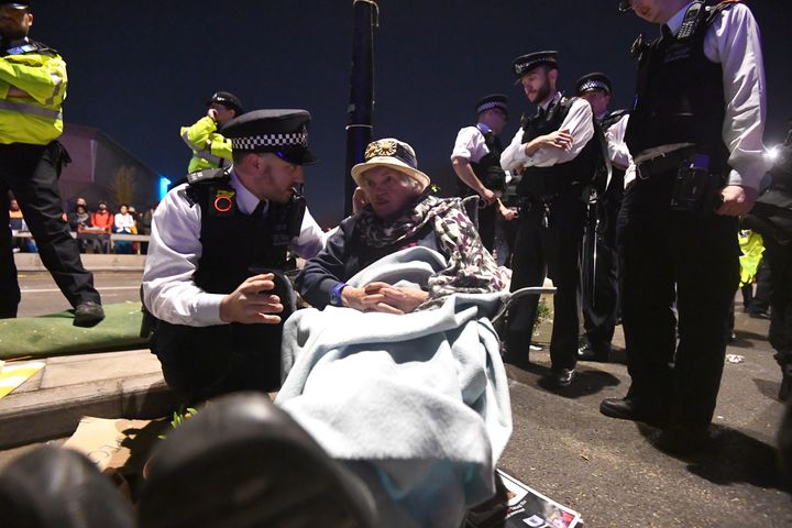 A police officer speaks to an older woman on Waterloo Bridge during the protests in London in April.