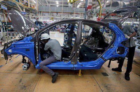 Workers on a car assembly line at the Tata Motors plant in Sanand, on the outskirts of Ahmedabad