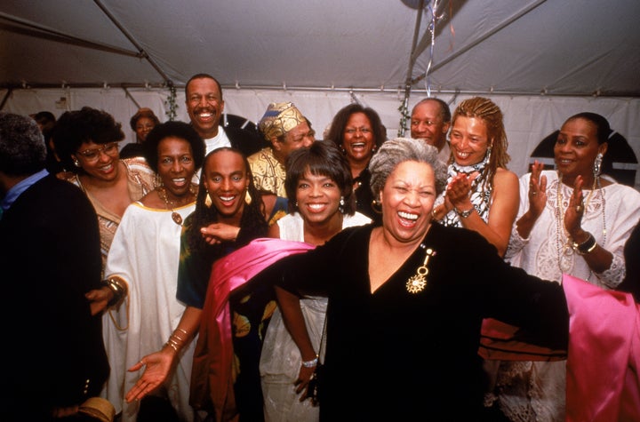 Nobel laureate Toni Morrison accepting the applause of partygoers Susan Taylor, Rita Dove, Oprah Winfrey, Angela Davis, Maya Angelou and others.