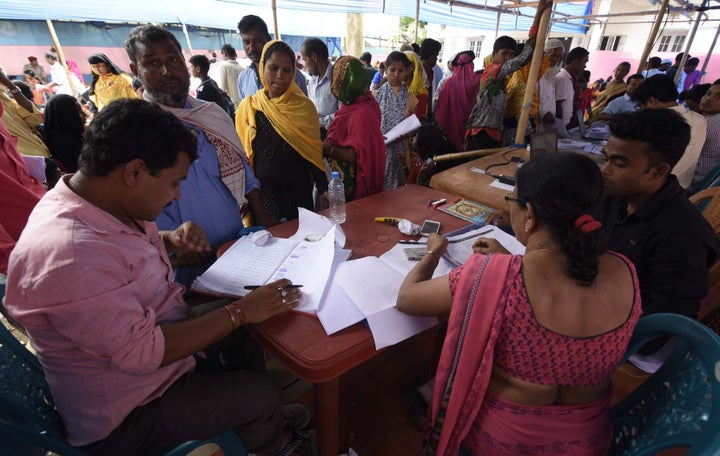 Assam State National Register of Citizens (NRC) officials check documents of residents during an appeal hearing against the non-inclusion of their names in the citizens register at an NRC office in Nagaon District of Assam, on June 3, 2019.