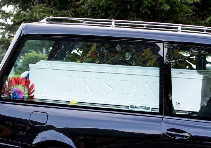 A hearse carried one large white coffin with the boys' names on each side 