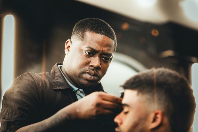 Leslie “Bud Tha Barber” Marks cuts a client's hair at Plus Midtown Barber and Beauty Salon in Atlanta.