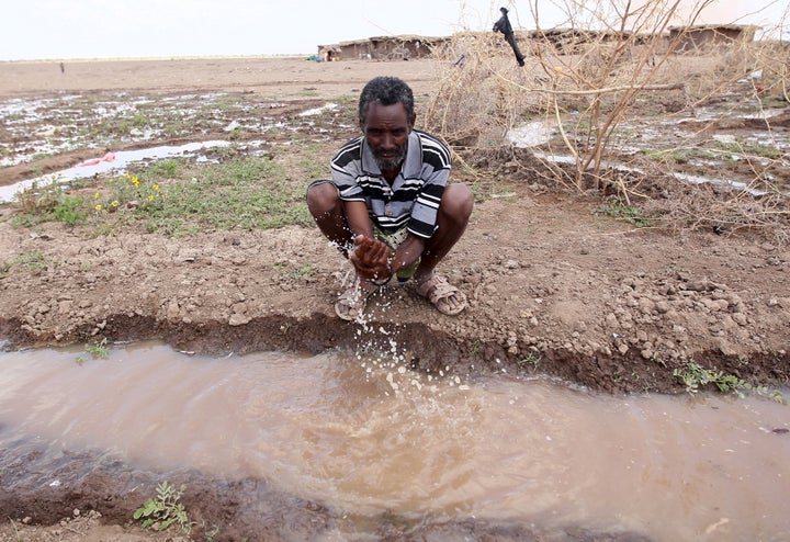 A man washes his hand in a trench in a drought-stricken region of Ethiopia in January 2016.