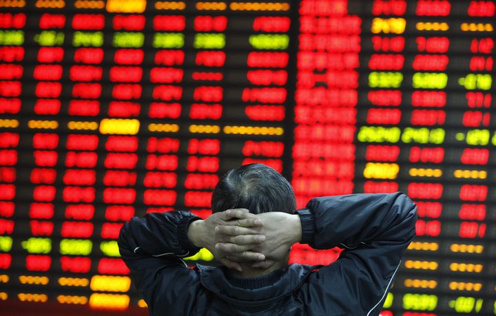 In this file photo, a trader watches stock prices at an exchange in Huaibei, China, April 10, 2015.