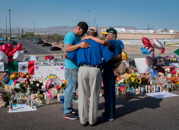 People pray at the makeshift memorial for victims of the shooting that left a total of 22 people dead at the Cielo Vista Mall Walmart, in El Paso, Texas, on Wednesday.