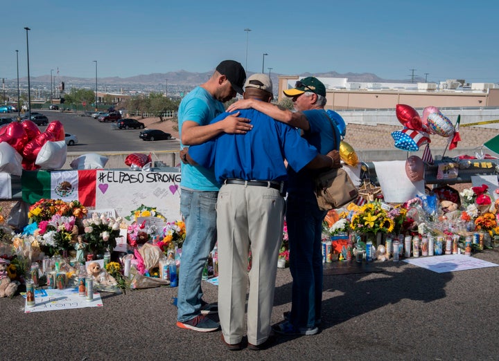 People pray at the makeshift memorial for victims of the shooting that left a total of 22 people dead at the Cielo Vista Mall