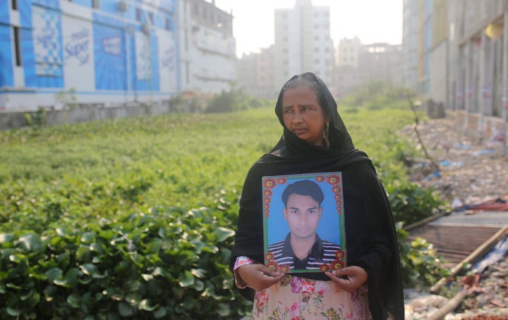 A woman holds a picture of a relative who went missing in the Rana Plaza building collapse, on the tragedy's sixth anniversary in Dhaka, Bangladesh, April 24, 2019.