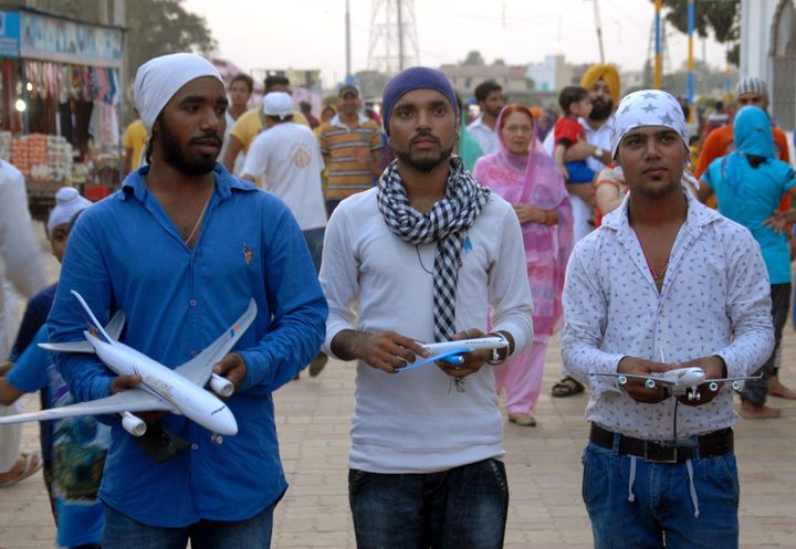 Devotees carry model aircraft to offer at a Sikh temple in Jalandhar, also known as 'Hawai Jahaaz Gurdwara' or Aeroplane Sikh shrine. Those who want to travel abroad sometimes leave model aircraft bearing the logos of international airlines at the temple in the belief that it will ease the granting of visas to travel out of India.