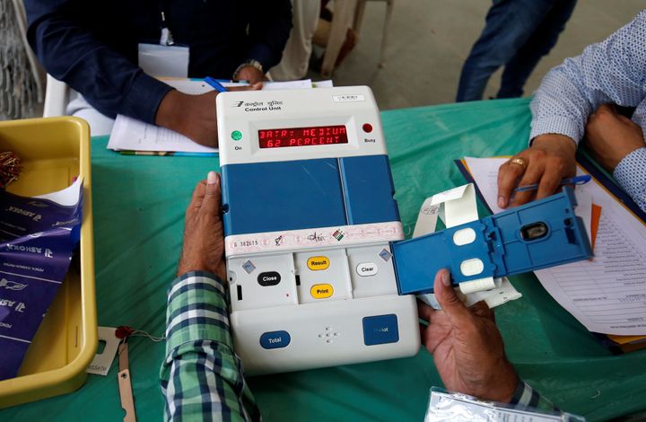 Election staff members open an electronic voting machine (EVM) to count votes inside a vote counting centre in Ahmedabad, India, May 23, 2019. 