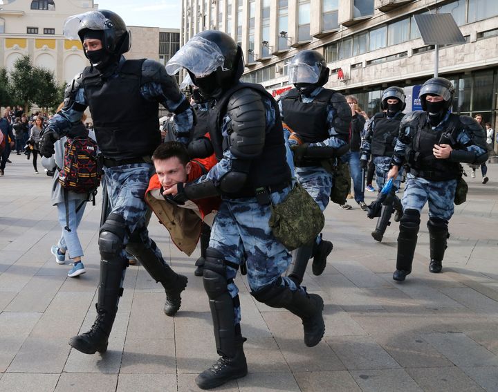 Police officers detain a protestor, during an unsanctioned rally in the centre of Moscow, Russia, Saturday, August 3, 2019. 