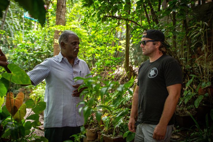 Nik Erickson of Fullmoon Farms, a Flower Co Supplier, speaks with a Kerala farmer to understand the cultivation process behind organic turmeric.