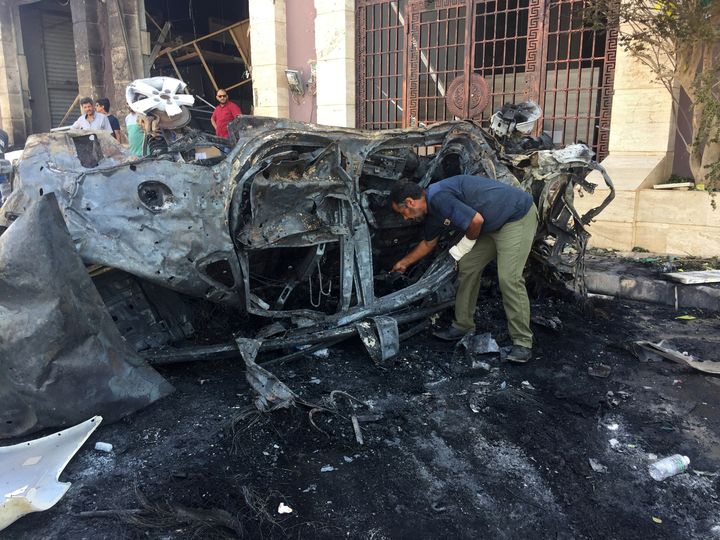 A security official inspects the site where a car bomb exploded in Benghazi, Libya August 10, 2019.