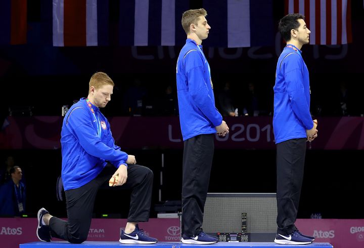 Gold medalist Race Imboden of United States takes a knee during the National Anthem Ceremony during the Lima 2019 Pan America