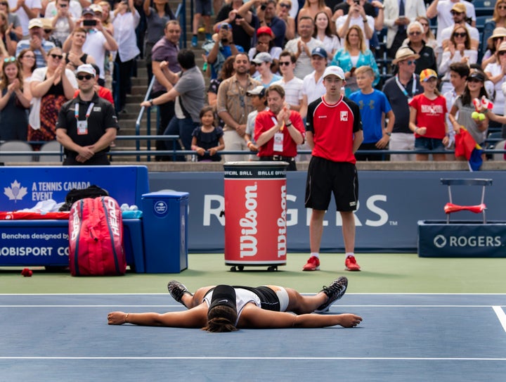 Bianca Andreescu lies on the court after her semifinal win at the Rogers Cup in Toronto on Aug. 10, 2019.