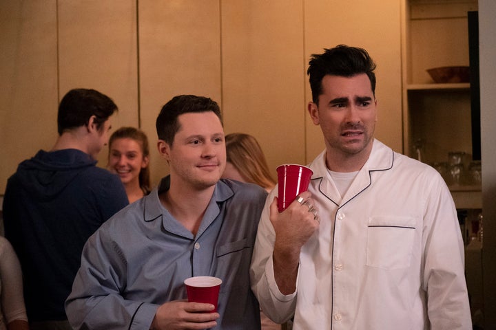 Noah Reid, left, and Dan Levy, right, as Patrick Brewer and David Rose in season five of "Schitt's Creek."