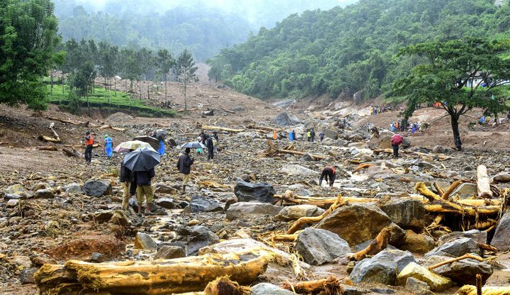 Volunteers, local residents and members of National Disaster Response Force (NDRF) search for survivors in the debris left by a landslide at Puthumala at Meppadi in the Wayanad district of Kerala on August 10. 