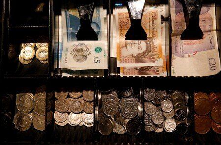 FILE PHOTO: Pound Sterling notes and change are seen inside a cash register in a coffee shop in Manchester
