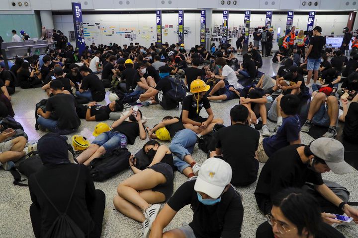 Protesters stage a sit-in protest at the Hong Kong International Airport, Monday, Aug. 12, 2019. 