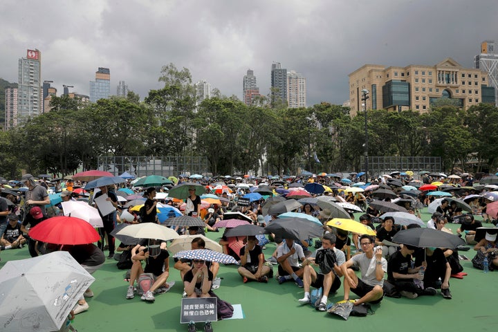 People holding umbrellas gather at Victoria Park to take part in an anti-extradition bill protest in Hong Kong, Sunday, Aug. 11, 2019. 