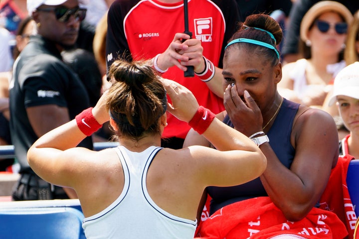 Bianca Andreescu left, sympathizes with Serena Williams, right background, after Williams retired from the Rogers Cup final on Sunday. 