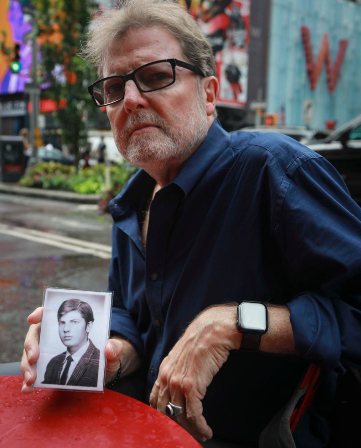 Brian Toale, a 66-year-old who says he was molested by an employee at a Catholic high school in Long Island, holds a photo of