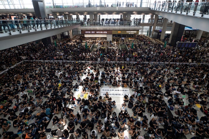 Protesters surround banners that read: "Those on the street today are all warriors!" center top, and "Release all the detaine