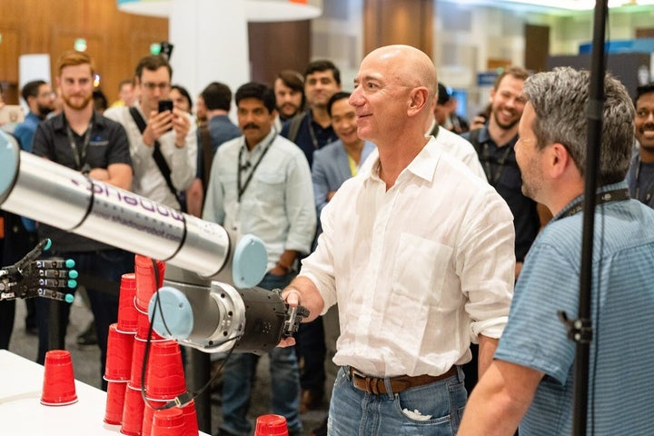 A Shadow Robot Company creation shakes hands with Amazon founder, Jeff Bezos.