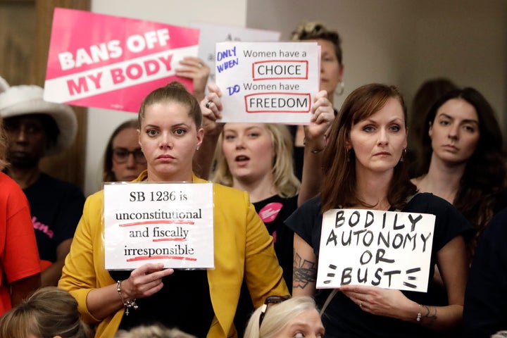 People wait for a Senate hearing to begin to discuss a fetal heartbeat abortion ban, or possibly something more restrictive, 