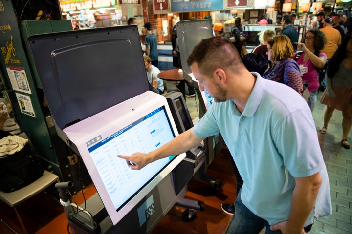 Steve Marcinkus, an Investigator with the Office of the City Commissioners, demonstrates the ExpressVote XL voting machine at