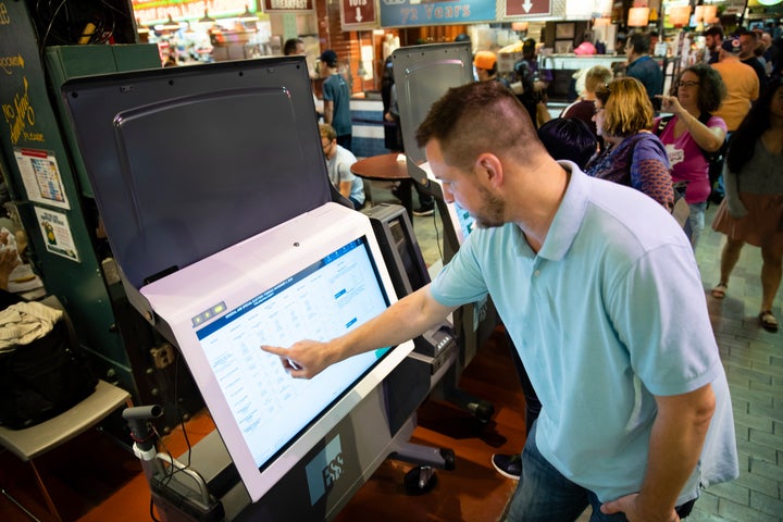 Steve Marcinkus, an Investigator with the Office of the City Commissioners, demonstrates the ExpressVote XL voting machine at the Reading Terminal Market in Philadelphia, Thursday, June 13, 2019. (AP Photo/Matt Rourke)