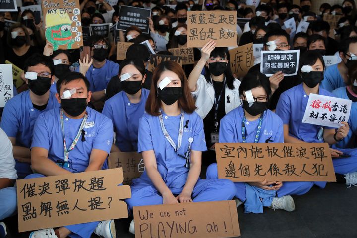 Medical staff stage a protest against police brutality on the protesters, at a hospital in Hong Kong
