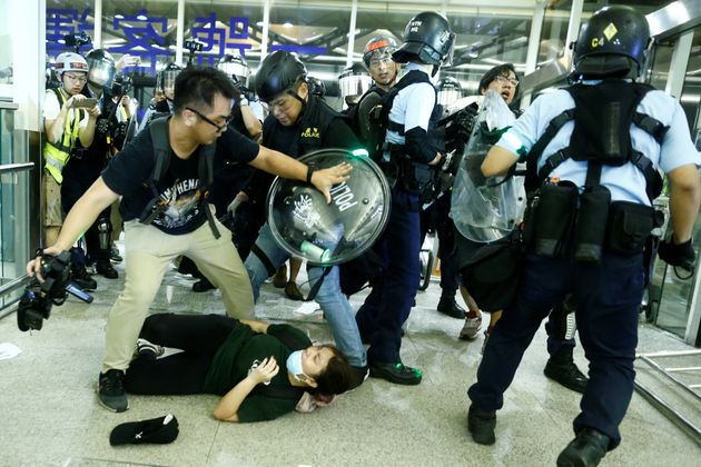 Protesters and police clash at the entrance to the building 