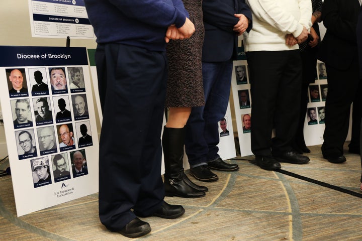Survivors of sexual abuse by clergy stand before photos of accused men during a news conference with lawyer Jeff Anderson of Jeff Anderson & Associates on February 14, 2019 in New York City.