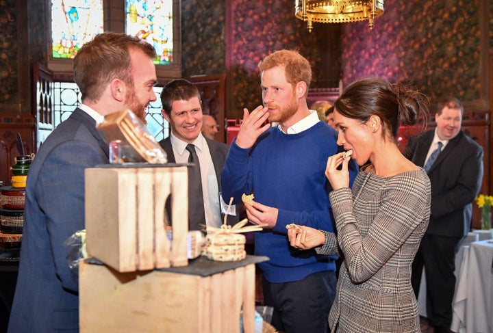 Prince Harry and Meghan Markle taste traditional cakes during a visit to Cardiff Castle.