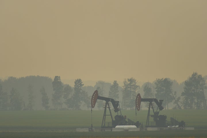 An extraction pump for oil and gas on a field near the town of Sundre during smoky and hazy weather conditions that blanketed the province of Alberta in the summer of 2018, impacted by B.C. wildfire smoke.