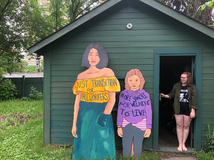 Emma Jackson, pictured in her backyard with two pieces from People On The Path. 