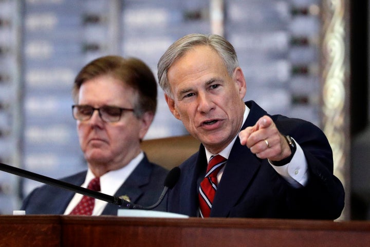 Texas Gov. Greg Abbott, right, sits beside fellow immigration hardliner Lt. Gov. Dan Patrick. Both will join a state task force that aims to ramp up efforts to surveil white nationalists.