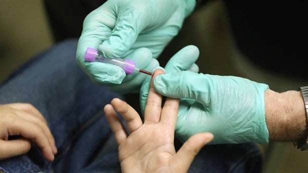 A nurse draws a blood sample from an elementary school student in Flint, Michigan. Some states use blood lead levels to deter
