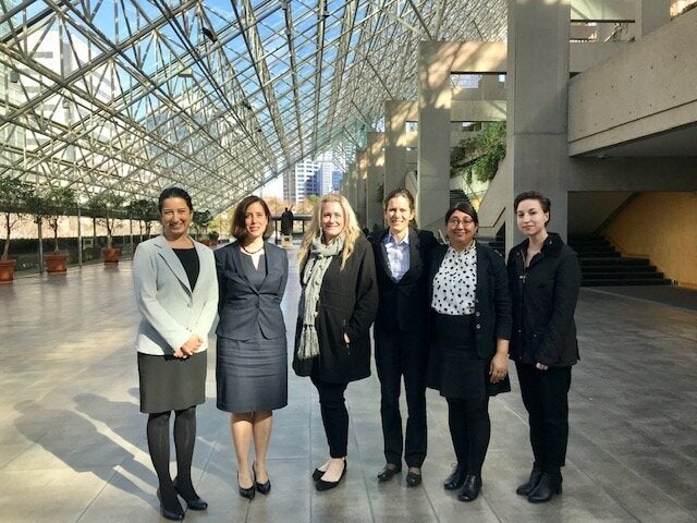 Nicole Bell, centre, and Raji Mangat, second from right, pose at a British Columbia courthouse.