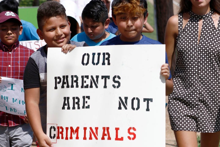In this Aug. 11, 2019 photo, children of mainly Latino immigrant parents hold signs in support of migrant workers picked up d