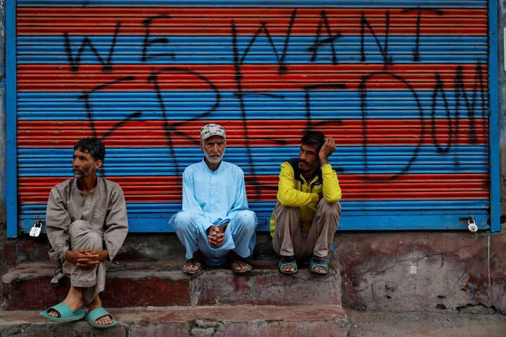 Kashmiri men wait before Eid-al-Adha prayers during restrictions after the scrapping of the special constitutional status for Kashmir, in Srinagar, August 12, 2019.