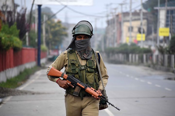 A soldier holds an assault rifle as he stands alert outside the venue of India's Independence Day celebration in Srinagar, Kashmir on August 15, 2019.